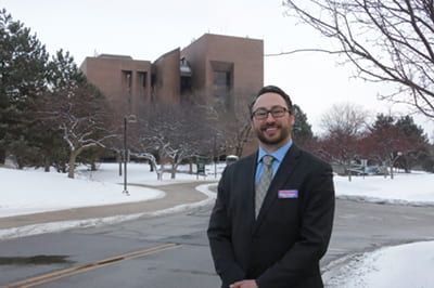 Brian Simons in front of the Cofrin Library.