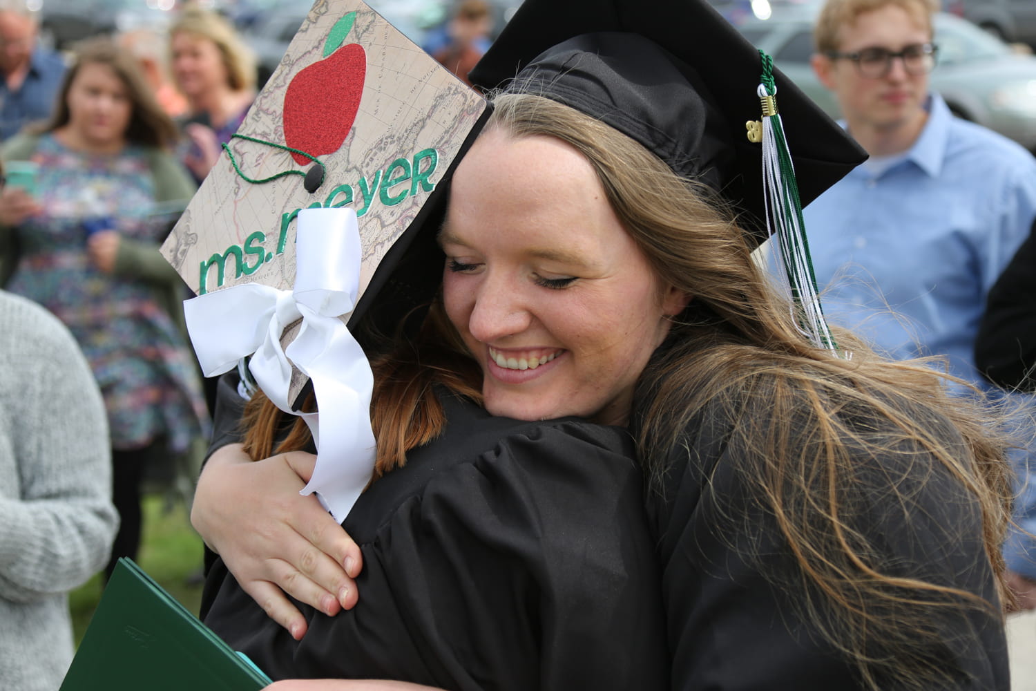 Students hug after commencement