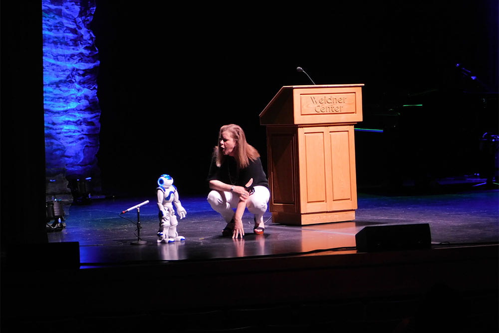 Kelli Strickland talks with UWGB robot on the Weidner Center main stage