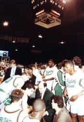 Mike Heideman in huddle with Phoenix Men's Basketball
