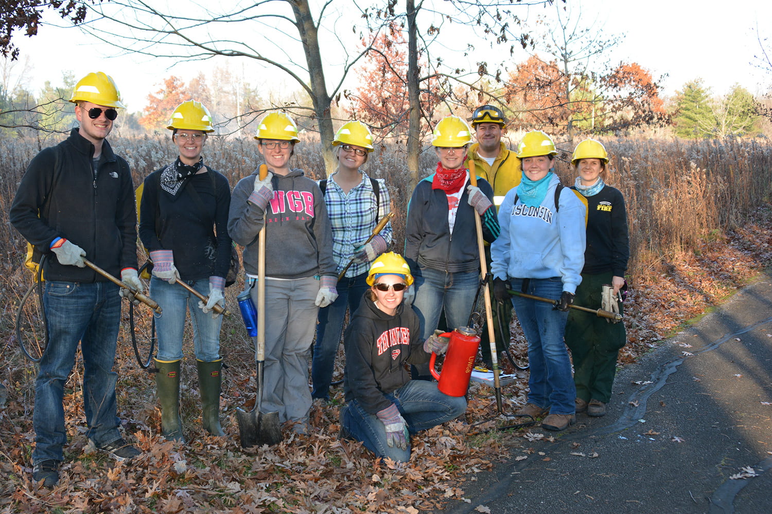 Cofrin center for biodiversit students helping Bobbie Webster with a controlled burn in the arboretum