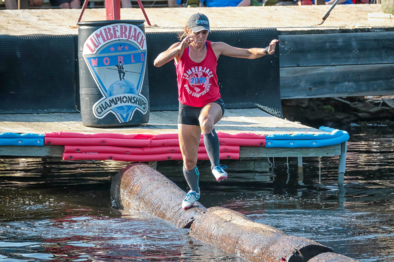 Katie Rick Burke running across floating logs