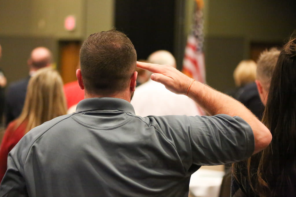 Saluting the flag at the UW-Green Bay Veterans Day Reception