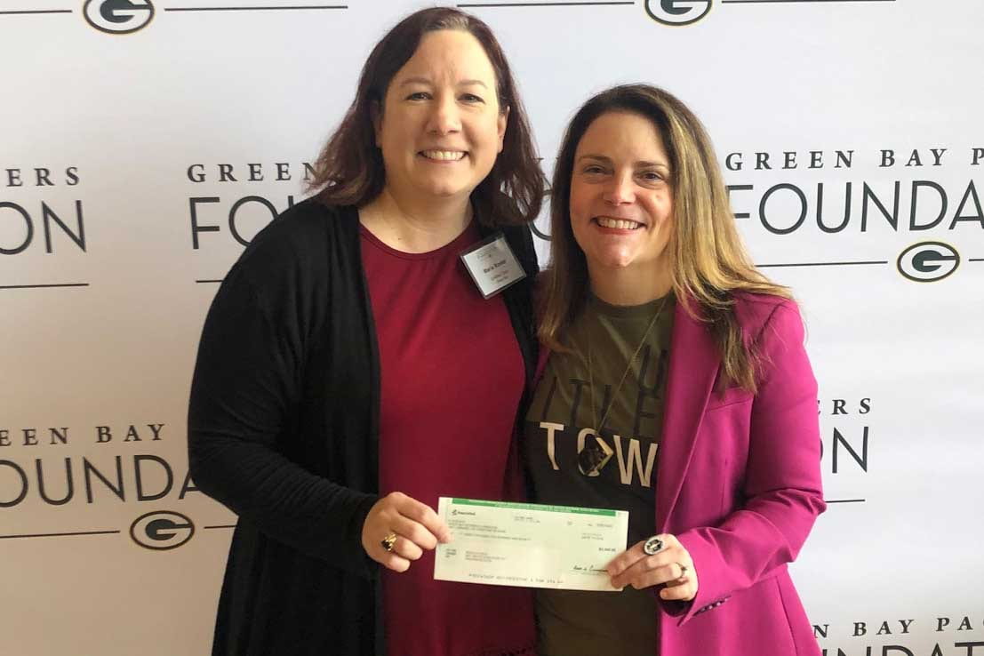 Rebecca Meacham recieves check from Green Bay Packers Founcation for UntiledTown