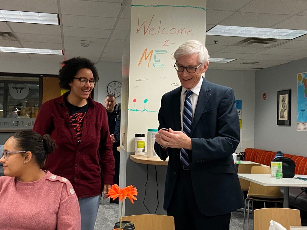 Candid photo of Governor Evers and student interacting