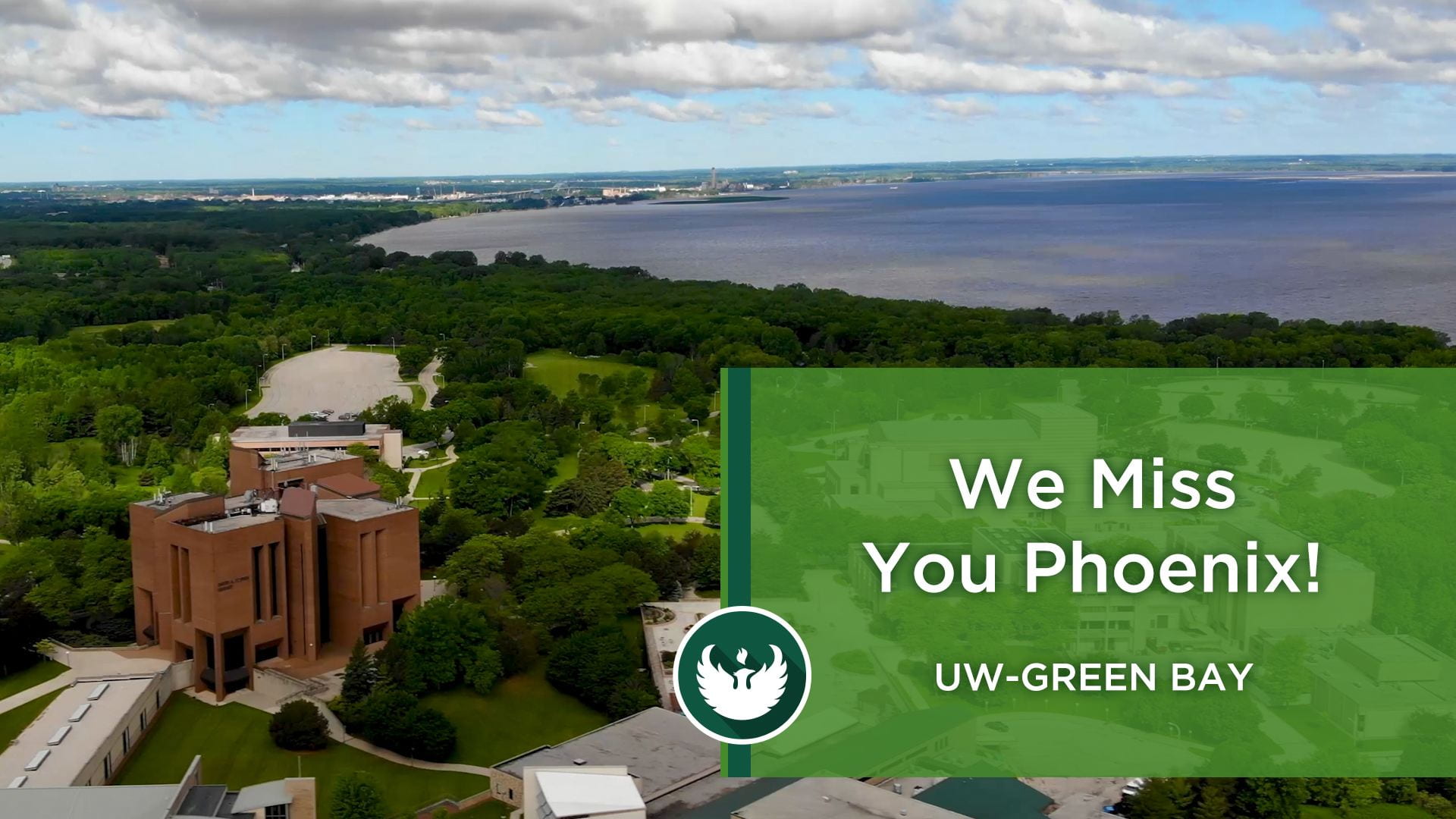 Image of the UW-Green Bay campus and the bay of Green Bay with a title "We Miss You Phoenix"