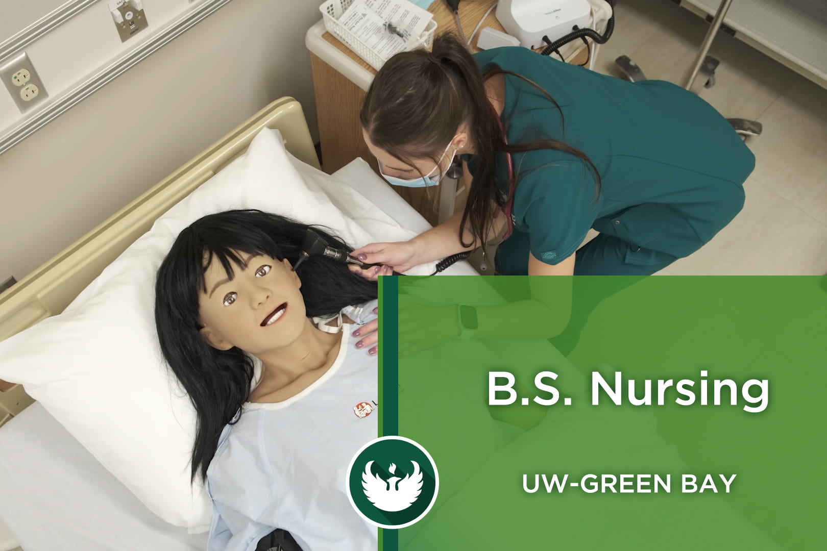 Photo of a UW-Green Bay nursing student using an otoscope on a high-tech mannequin inside the new Nursing Skills Center at the Green Bay campus.