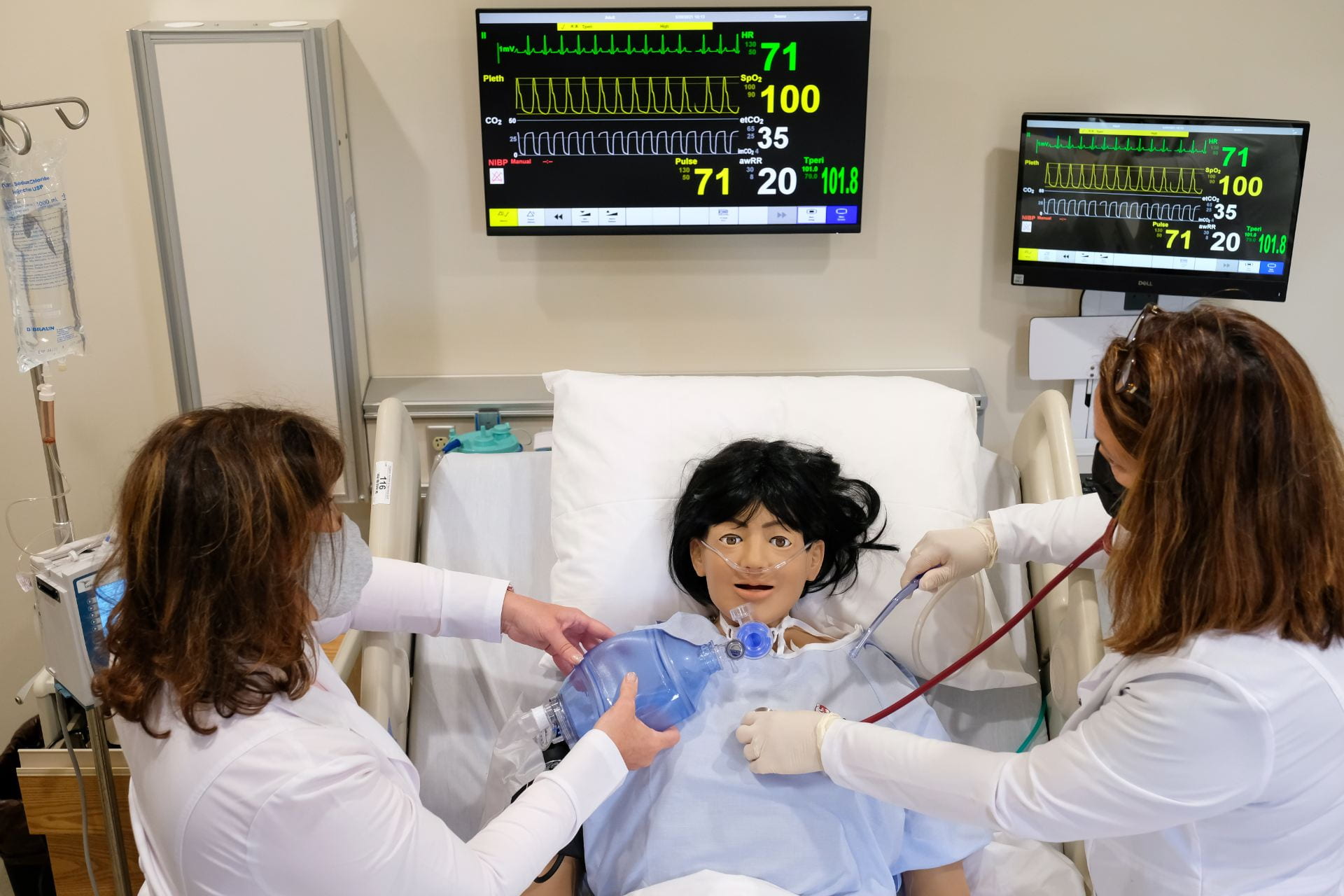 Two nursing instructors train on the new hi-tech human patient simulator inside the Aurora BayCare Nursing Skills Center on the UW-Green Bay Campus.