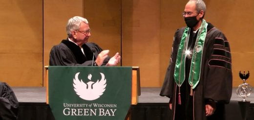 Interim UW System President Tommy Thompson claps after putting the Chancellor medallion around Chancellor Michael Alexander's neck during the Installation of Michael Alexander, the seventh Chancellor of UW-Green Bay on Thursday, September 30, 2021.