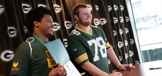 Packer player Cole Van Lanen poses with a student at College Draft Day at Lambeau Field