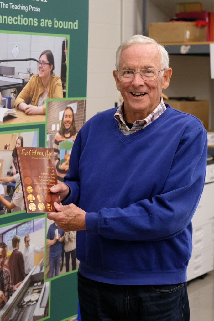 Phil Hauck hold a copy of "The Golden Age of Brown County Enterprise"