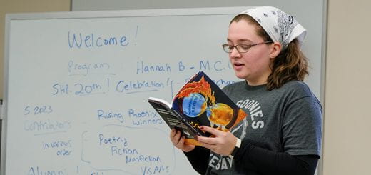 A student-author reads her story that was published in the “Sheepshead Review”, a International journal of arts and literature, during the launch party of the Spring 2023 issue inside a classroom at UW-Green Bay.