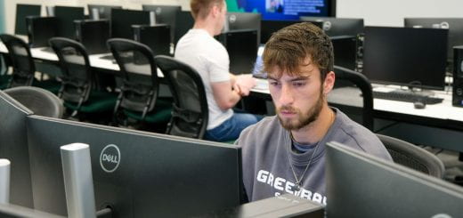 A Finance student Joshua Johansen, sits in front of two monitors as he works on homework inside the Willie D. Davis Finance and Investment Lab on the UW-Green Bay campus.