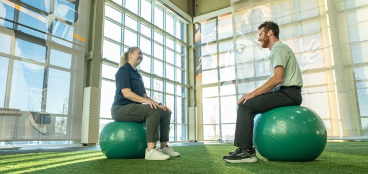 Alexa Bentley and her mentor sit across from each other on large exercise core stabiliation balls as they discuss clearing the mind and focusing on the core strength during her practicum experience at Aurora BayCare. Alexa is a graduate studies student in Sport, Exercise, and Performance Psychology program at UW-Green Bay.